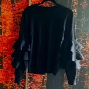 Ruffle sleeve black sweater top.